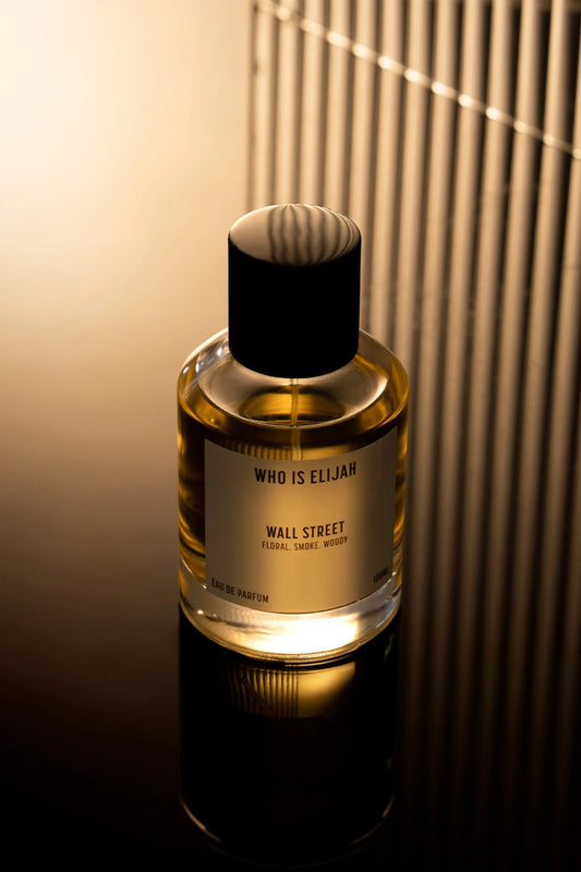 Wall Street by Who Is Elijah, a smoky, woody floral fragrance with rose, raspberry, Egyptian geranium, oud, incense, saffron, amberwood, and leather.
