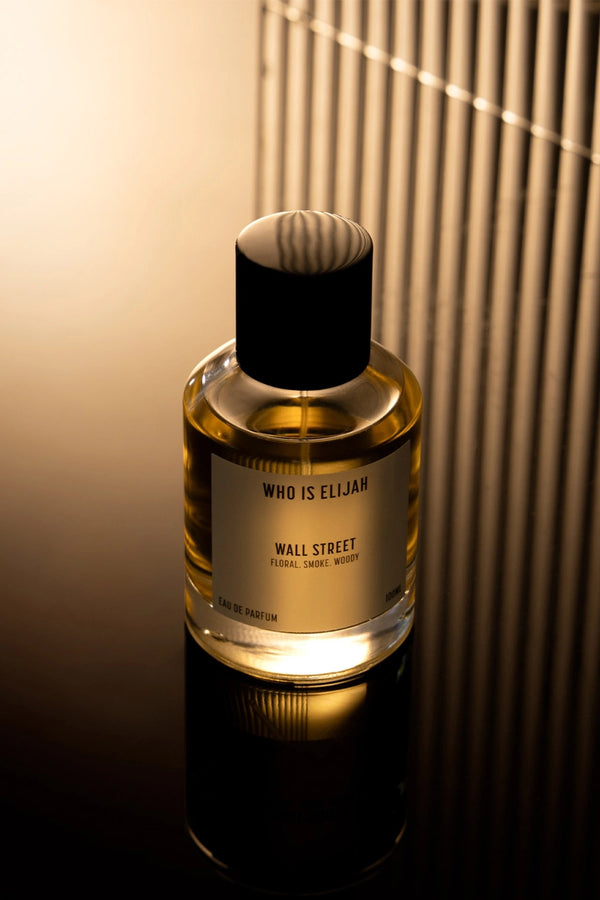 Wall Street by Who Is Elijah, a smoky, woody floral fragrance with rose, raspberry, Egyptian geranium, oud, incense, saffron, amberwood, and leather.