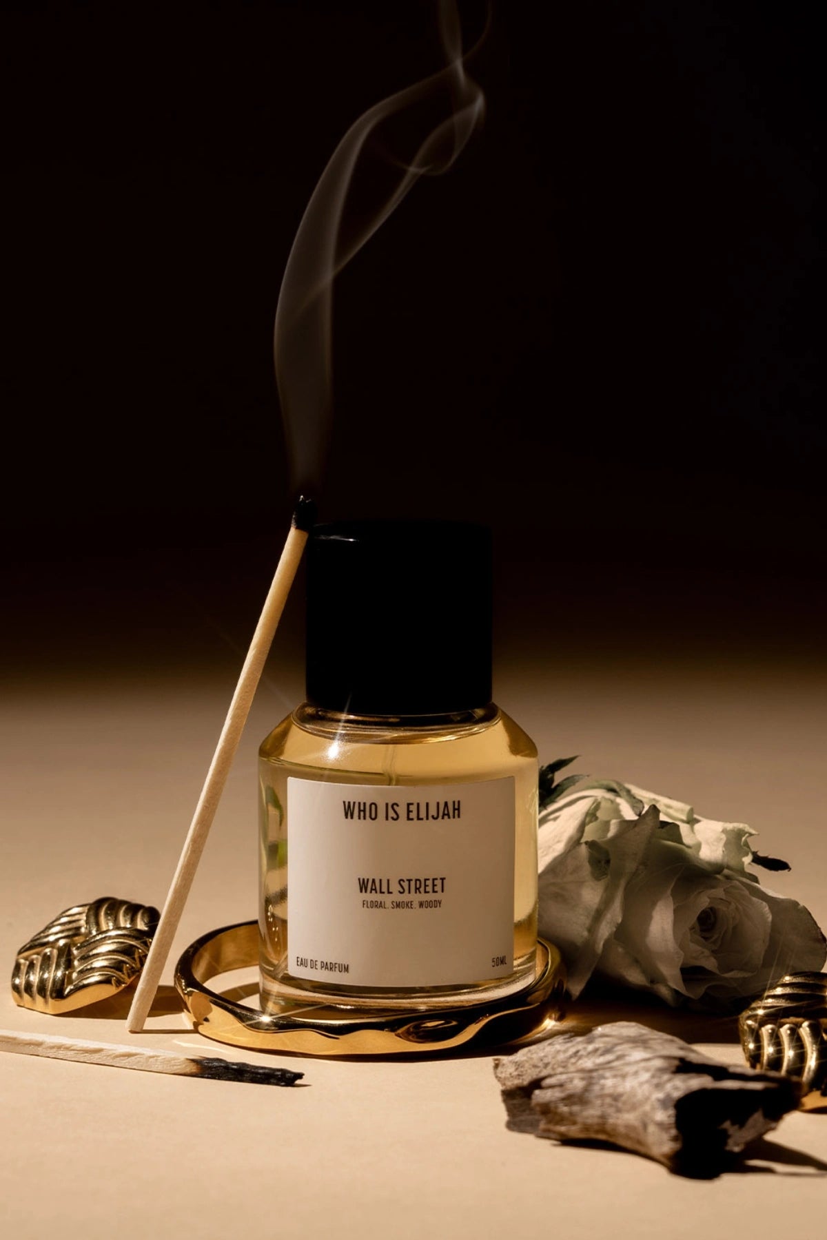 Wall Street by Who Is Elijah, a floral, smoky, and woody fragrance with rose, raspberry, oud wood, incense, saffron, amberwood, benzoin, and leather.