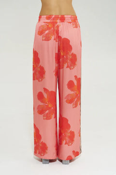 Wide Leg Pant Peach Petals by Summi Summi, features oversized floral prints on a flowy peach base. Perfect for resort lounging or beach days.