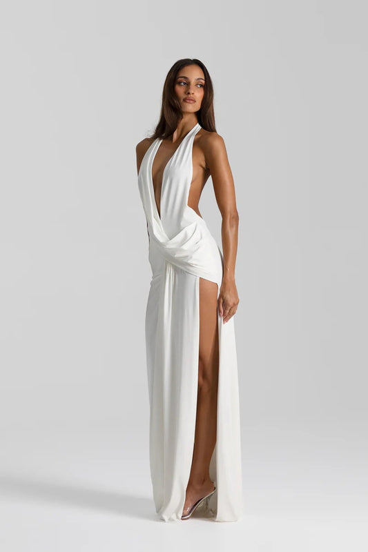 Winona Gown White by Natalie Rolt – a draped halter gown with open back and side split. Perfect for formal evening events.