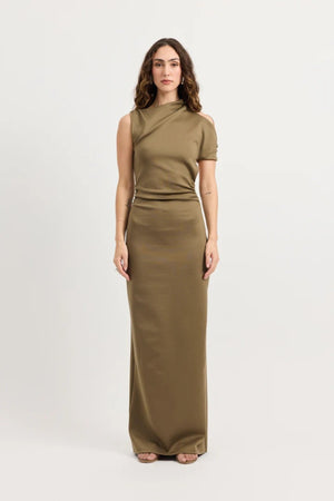 Xyla Dress by Tojhà – a clay jersey maxi with an asymmetric neckline, wrapped arm detail, and soft tucks, perfect for modern evening styling.