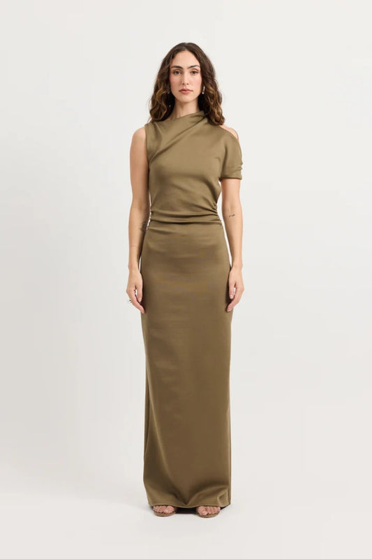 Xyla Dress by Tojhà – a clay jersey maxi with an asymmetric neckline, wrapped arm detail, and soft tucks, perfect for modern evening styling.