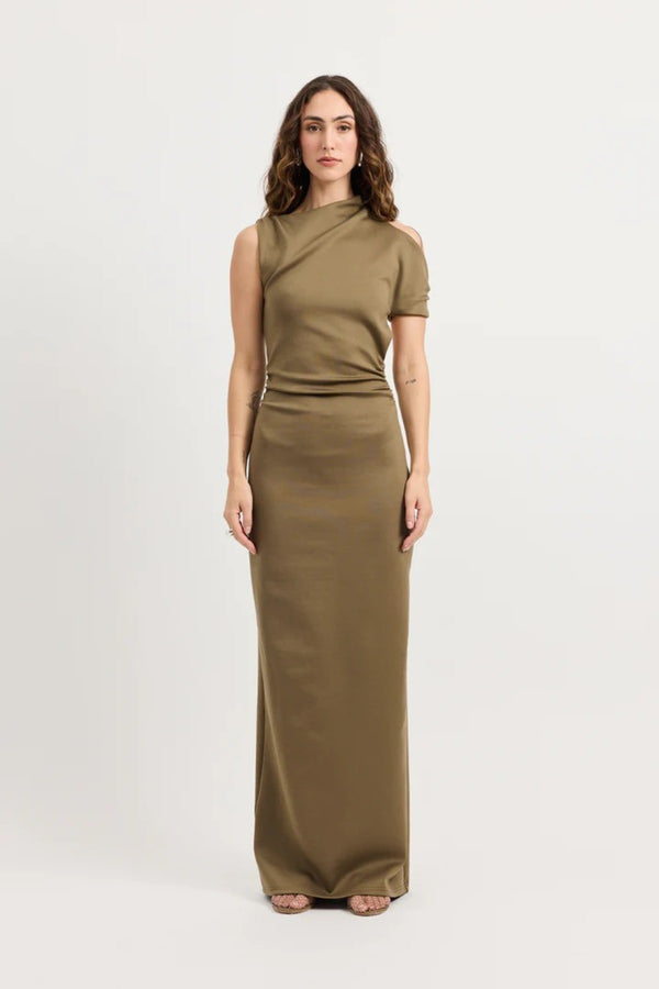 Xyla Dress by Tojhà – a clay jersey maxi with an asymmetric neckline, wrapped arm detail, and soft tucks, perfect for modern evening styling.