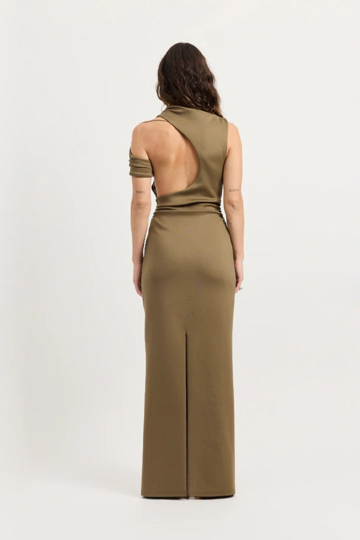 Xyla Dress by Tojhà – a clay jersey maxi with an asymmetric neckline, wrapped arm detail, and soft tucks, perfect for modern evening styling.