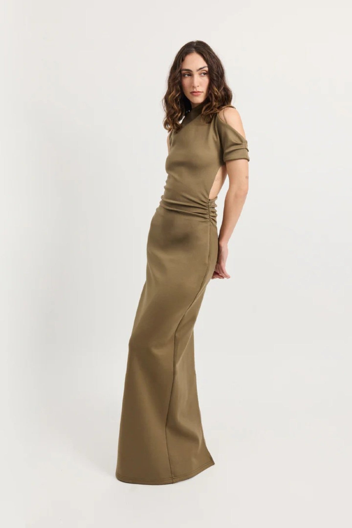 Xyla Dress by Tojhà – a clay jersey maxi with an asymmetric neckline, wrapped arm detail, and soft tucks, perfect for modern evening styling.