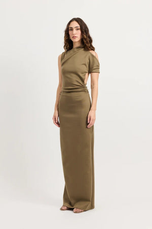 Xyla Dress by Tojhà – a clay jersey maxi with an asymmetric neckline, wrapped arm detail, and soft tucks, perfect for modern evening styling.