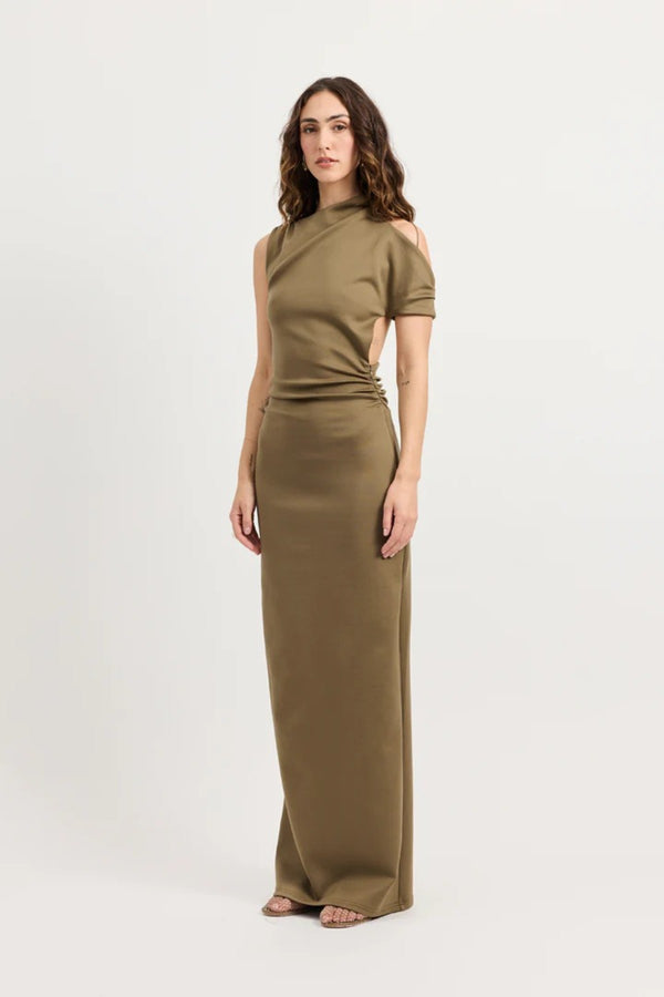 Xyla Dress by Tojhà – a clay jersey maxi with an asymmetric neckline, wrapped arm detail, and soft tucks, perfect for modern evening styling.