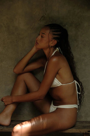 Zali Bottom in Core Cream by Khamì – mid-rise swimwear with ruched adjustable coverage, made from recycled fabric. A poolside staple.