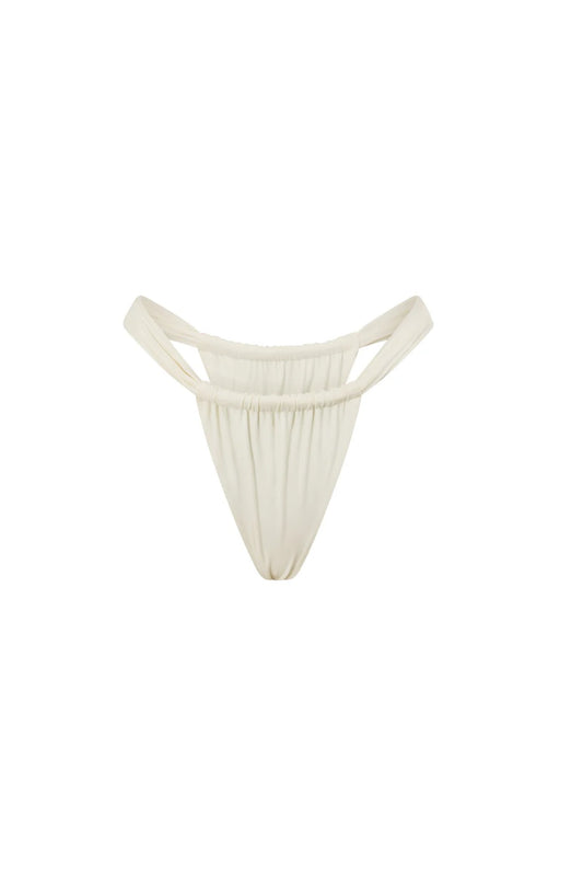 Zali Bottom in Core Cream by Khamì – mid-rise swimwear with ruched adjustable coverage, made from recycled fabric. A poolside staple.