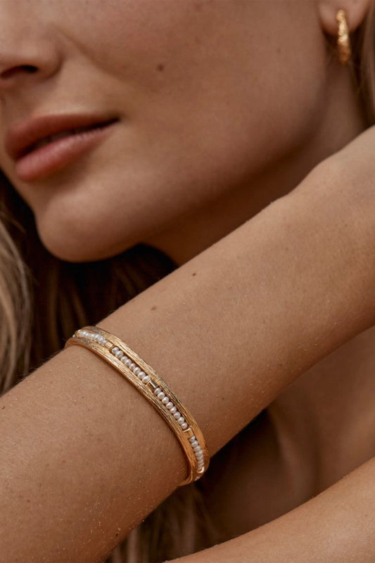 Zuni Bracelet by Amber Sceats - gold cuff bracelet with freshwater pearls, designed for a bold elevated statement look.