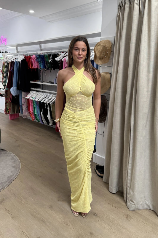 Hudson Lace Maxi Dress Butter by Benni, elegant stretch lace dress with twist halter neck, ruched seams, and sheer waist panel for a bold evening look.