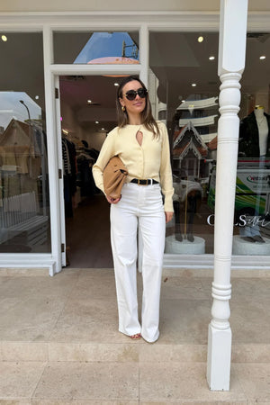 Soft, custard-colored Alani cardigan with long sleeves and a relaxed fit, perfect for layering.