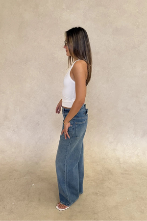 White Bronte halter tank top made of soft jersey fabric with a fitted silhouette and sleeveless design.