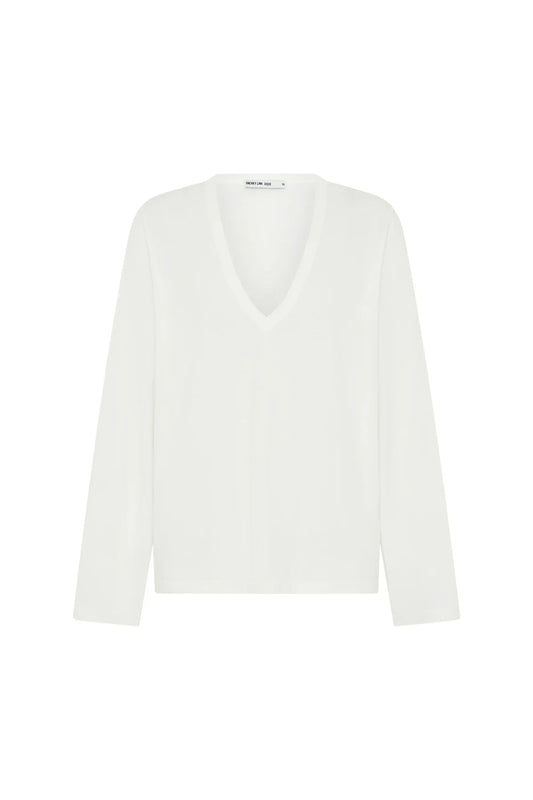 White Carter V Neck long sleeve top displayed on a mannequin with a fitted silhouette and soft fabric texture.