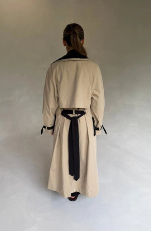 Beige Dakota Contrast Trench Coat with black lapels and belt, featuring a classic double-breasted design.