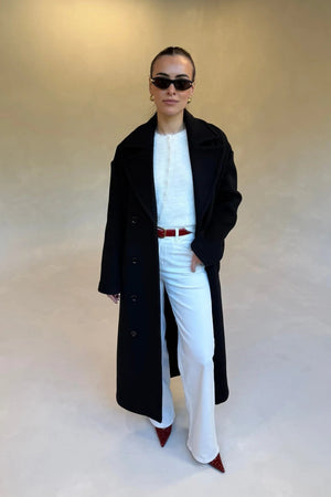 Black double-breasted coat with wide lapels and front buttons, designed for a tailored fit.