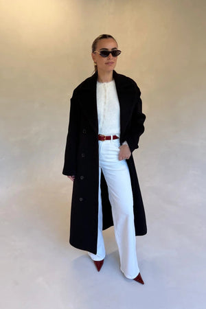 Black double-breasted coat with wide lapels and front buttons, designed for a tailored fit.