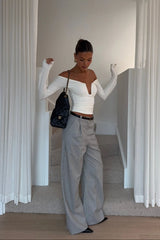 White off-shoulder top with ruffled neckline and short sleeves, designed by Ella Squire.