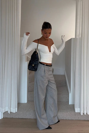 White off-shoulder top with ruffled neckline and short sleeves, designed by Ella Squire.