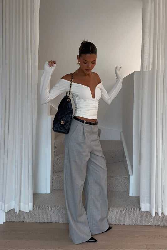 White off-shoulder top with ruffled neckline and short sleeves, designed by Ella Squire.