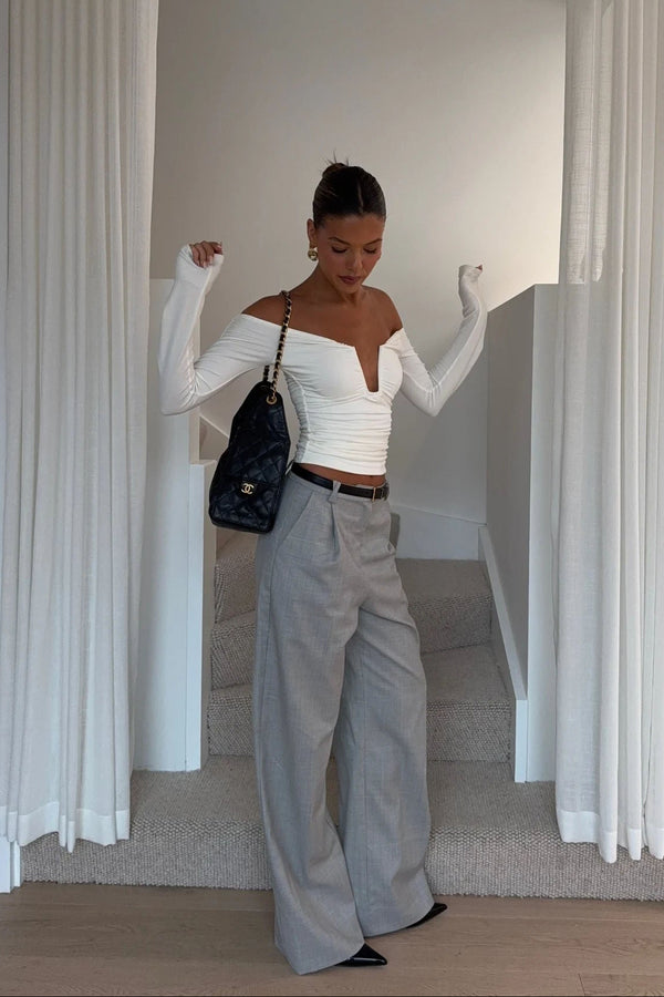 White off-shoulder top with ruffled neckline and short sleeves, designed by Ella Squire.