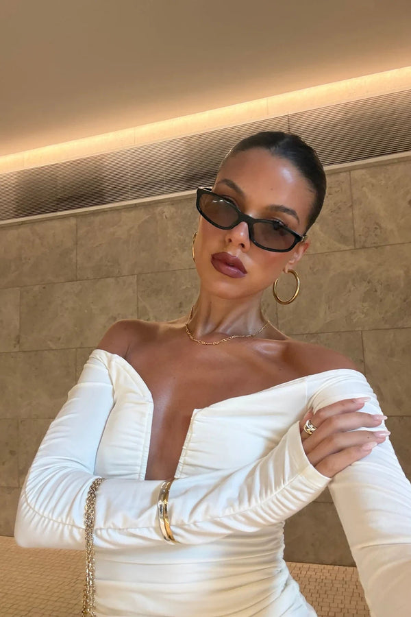 White off-shoulder top with a relaxed fit and subtle texture, designed by Ella Squire.