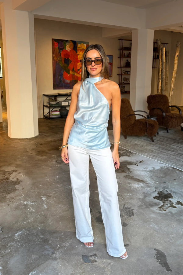 Blue Elody scarf top with a draped neckline and sleeveless design on a white background.