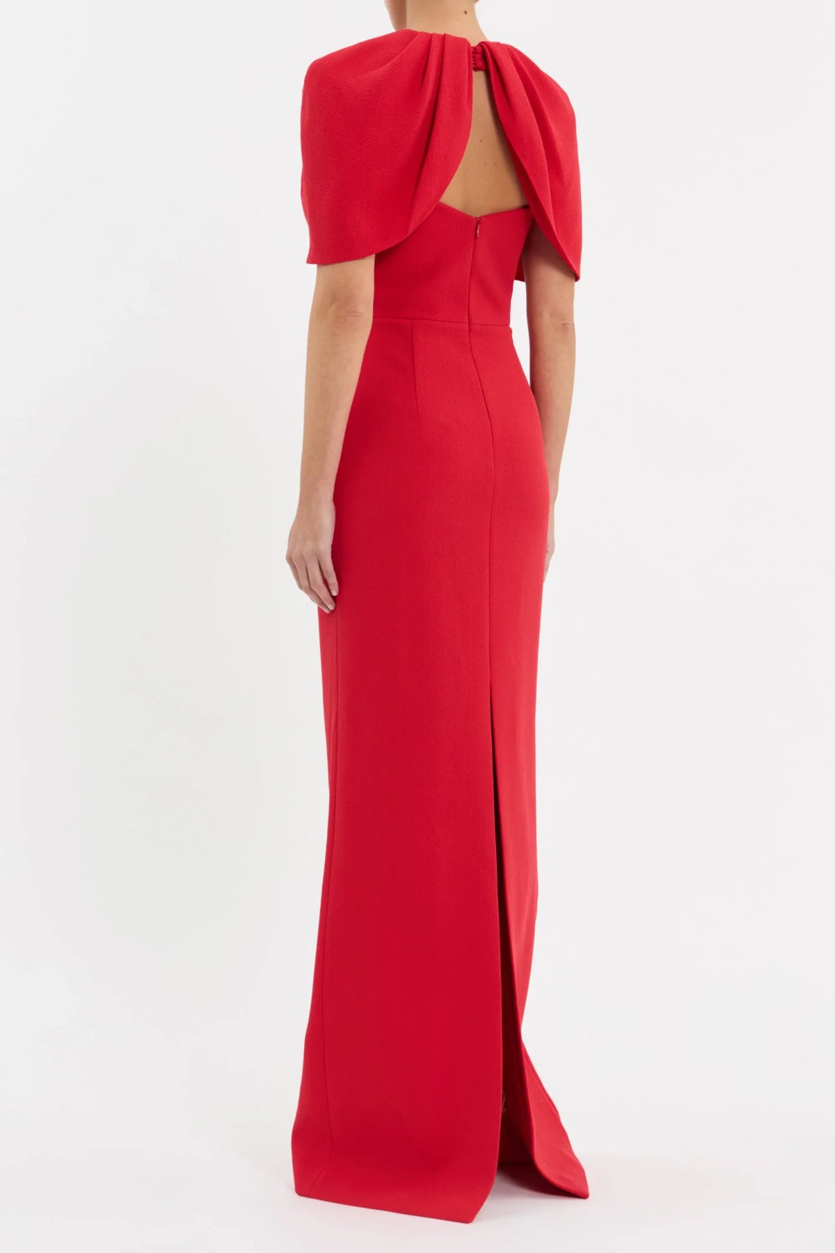 Rebecca Vallance Cameron Gown in red bonded crepe with draped cape overlay, V neckline and column maxi skirt, elegant evening style.
