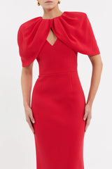 Rebecca Vallance Cameron Gown in red bonded crepe with draped cape overlay, V neckline and column maxi skirt, elegant evening style.
