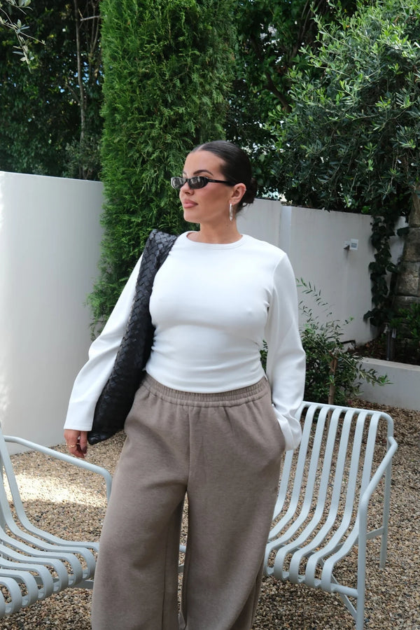 White Jaz crew neck top with ruched long sleeves and a fitted silhouette.