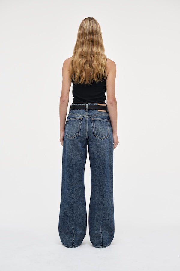 Coco Relaxed Psychocandy by Neuw Denim, trendy high-waisted jeans with a relaxed straight-leg fit and elongating silhouette. Perfect for a laid-back or tailored look in a mid-vintage indigo wash with signature Neuw Denim details.