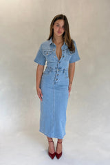 Light blue denim midi dress with short sleeves and a button-down front, styled with a relaxed fit.