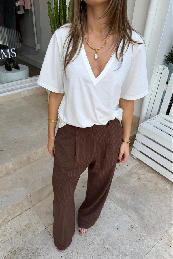 Kinsley Pinstripe Tailored Pant in chocolate brown with thin vertical white stripes and a slim, tailored fit.