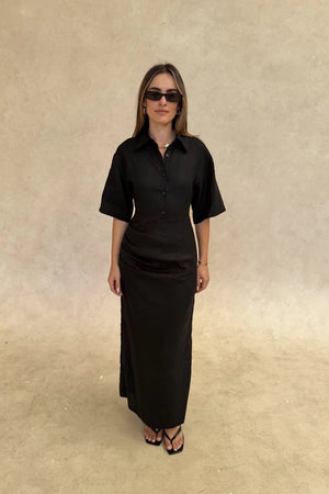Black Lefka midi dress with short sleeves and a fitted waist, featuring a subtle flare at the hem.