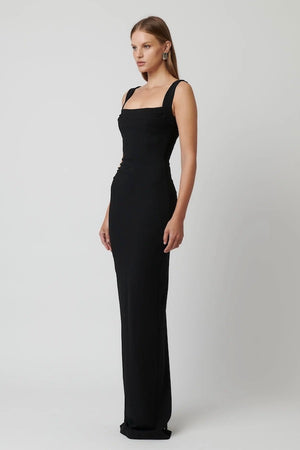 Marbella Gown Black by Effie Kats – A sleek black gown with bustier-inspired bodice, draped detail, and split hem for graceful movement.