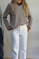 Woman wears Millie Relaxed Long Sleeve Tee in chocolate stripe with white high-rise jeans and brown strappy heeled sandals.
