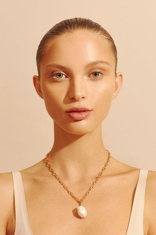 Chi Necklace by Amber Sceats, a trendy, timeless piece featuring a 24k gold-plated chain and unique freshwater pearl, perfect for elevating any look.