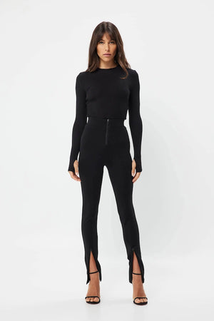 The Brooklyn Top Black by Mossman is a lightweight, fitted knit with a high round neckline and long sleeves with thumb openings.