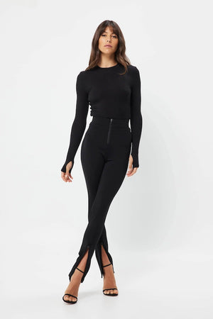 The Brooklyn Top Black by Mossman is a lightweight, fitted knit with a high round neckline and long sleeves with thumb openings.