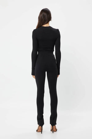 The Brooklyn Top Black by Mossman is a lightweight, fitted knit with a high round neckline and long sleeves with thumb openings.