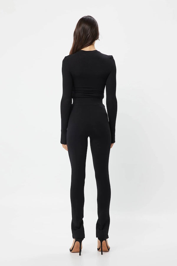 The Brooklyn Top Black by Mossman is a lightweight, fitted knit with a high round neckline and long sleeves with thumb openings.