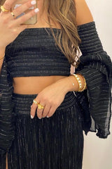 Calypso Skirt Black Gold by D Artemide, maxi skirt with shirred waist and front split. Perfect for beach days or effortless summer looks.