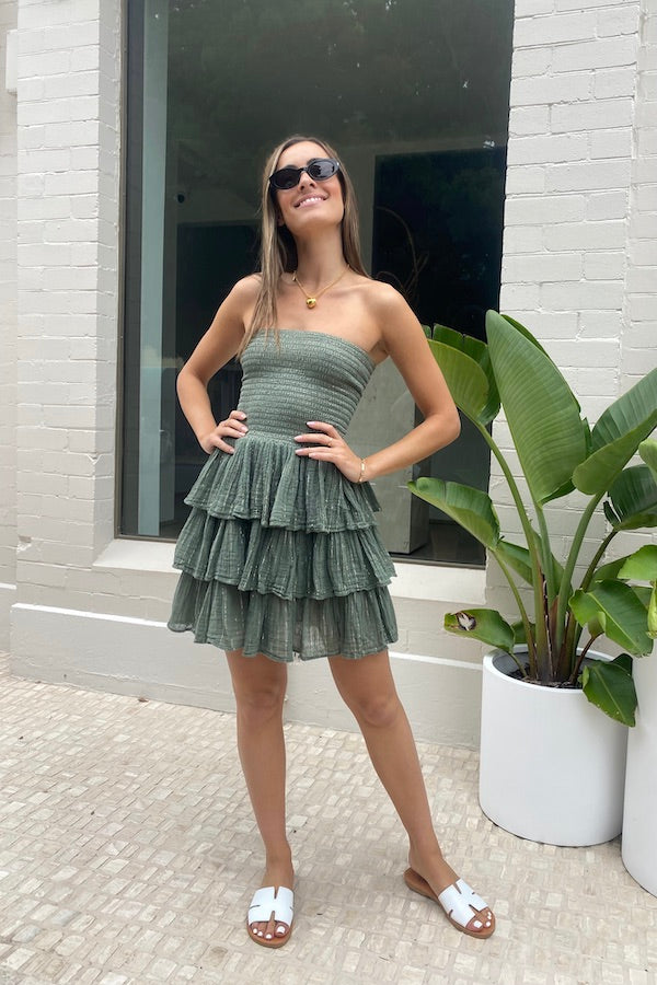 Doris Mini Dress Khaki Gold by D' Artemide – a tiered mini with shirred bodice and soft drape. Perfect for summer styling.