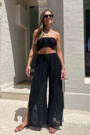 Ruched Tube Top Black by D’Artemide, Cotton bandeau with ruched back and front tie detail for easy summer layering or elevated resort styling.